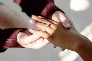 white gold engagement ring on hand with diamonds